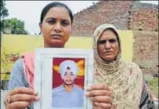  ??  ?? Bhoewal village residents Gurpinder Kaur (left) and her mother with a picture of Gurpinder’s brother Manjinder Singh. HT PHOTO