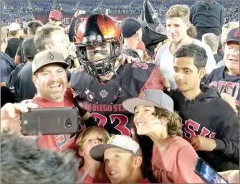  ?? Photo submitted by Stephanie Truitt ?? Former Siloam Springs football standout and current San Diego State safety Parker Baldwin poses for a selfie with Aztec fans after San Diego State upset Stanford last season.