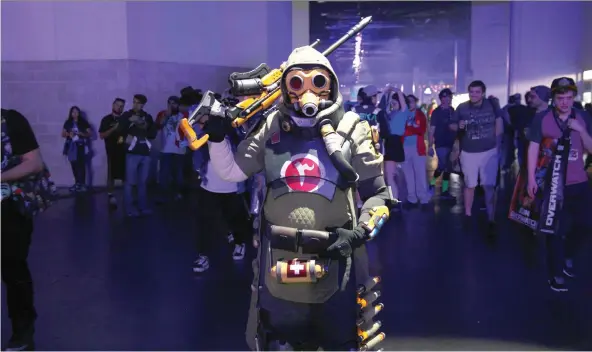  ?? PHOTOS: NOAH SMITH ?? A cosplayer dresses up as Overwatch Hero Ana at BlizzCon. The world of esports continues to expand, complete with dedicated fans similar to those found at NFL stadiums.