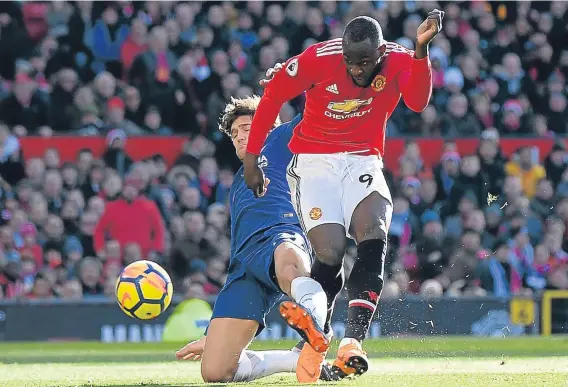  ??  ?? Romelu Lukaku scores Manchester United’s first goal during their 2-1 Premier League win over Chelsea at Old Trafford on Sunday.