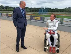  ??  ?? Minister for Disabled People Justin Tomlinson meets with Paralympic wheelchair fencing gold medallist Piers Gilliver