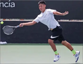  ?? Katharine Lotze/The Signal ?? (Above) Saugus singles player Erin Pang reaches to return a hit during a tennis match against Batis Golestany of Valencia at the Foothill League prelims at the Paseo Club on Wednesday. (Below) Valencia doubles partners Jackson Boxall, left, and Stephen...