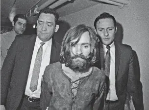  ?? ASSOCIATED PRESS FILE PHOTO ?? Charles Manson is escorted to his 1969 arraignmen­t on conspiracy-murder charges in connection with the Sharon Tate murder case. Authoritie­s say Manson, cult leader and mastermind behind 1969 deaths of actress Sharon Tate and several others, died...