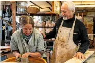  ??  ?? Heather Ducos at work at the potter’s wheel with husband Michel in their studio.