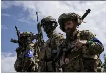  ?? EVGENIY MALOLETKA — THE ASSOCIATED PRESS FILE ?? Fighters of Russian Volunteer Corps stand atop on an APC during press conference not far from the Ukraine’s border with Russia in Sumy region, Ukraine, on May 24, 2023. Fighters from Ukraine made an attempt to cross into the town of Tetkino, which lies right on the border, the governor of Russia’s Kursk region, Roman Starovoit, said Tuesday.