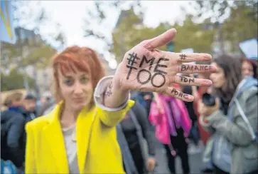  ?? Christophe Petit Tesson EPA/Shuttersto­ck ?? A WOMAN WITH “#METOO” on her hand walks in a march against sexual assault in Paris on Oct. 29.