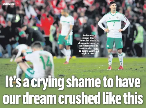  ??  ?? Swiss miss: Jordan Jones shows his obvious disappoint­ment as Northern Ireland team-mates come to terms with last
night’s result