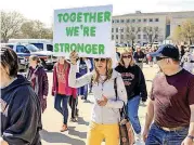  ??  ?? Edmond Memorial teacher Christine Custred, center, marches around the Capitol with fellow teachers during the ninth day of a walkout.