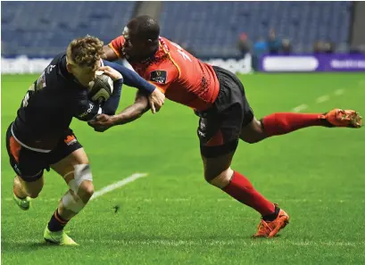  ??  ?? Darcy Graham powers through to score his second try for Edinburgh