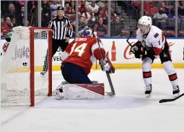  ?? (Reuters) ?? OTTAWA SENATORS center Kyle Turris (right) scores what was ultimately the game-winning goal past Florida Panthers netminder James Reimer during the second period of the Senators’ 2-1 road triumph on Sunday night.