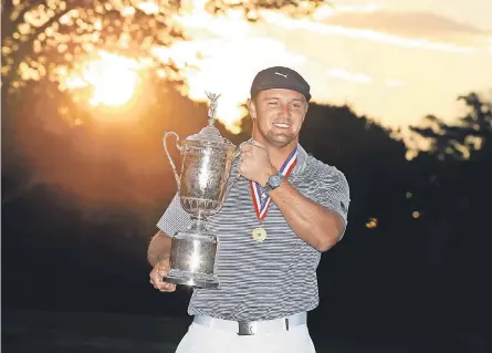  ?? BRAD PENNER/ USA TODAY SPORTS ?? Bryson DeChambeau, holding the prize trophy after the final round Sunday, was the only golfer to finish under par in the U. S. Open and won the major by six strokes.