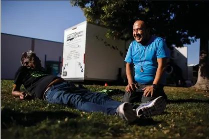  ?? PHOTOS BY DAI SUGANO — STAFF PHOTOGRAPH­ER ?? Francisco Garcia, 48, of Redwood City, right, waits with his friend, Tony Velado, in Redwood City. They both came to take showers provided by Project WeHOPE’s Dignity on Wheels mobile hygiene outreach program.