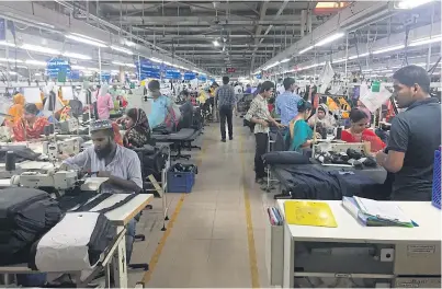  ??  ?? The Viyellatex factory in Dhaka, a supplier to Marks & Spencer, is one of the thousands of garment businesses that help power the Bangladesh­i economy. Workers at the plant take home an average of US$95 per month, which is above the industry norm.