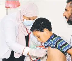  ??  ?? File photo shows Nahla Arishi, a pediatrici­an, checking a boy infected with diphtheria at the al-Sadaqa teaching hospital in the southern port city of Aden. — Reuters photo