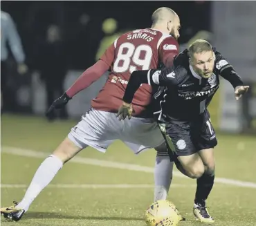  ??  ?? 2 Hibs striker Martin Boyle evades the close attentions of Georgios Sarris during Saturday’s game in Hamilton.