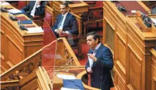  ??  ?? Opposition SYRIZA leader Alexis Tsipras (right) challenges Prime Minister Kyriakos Mitsotakis as he looks on in the Greek Parliament in Athens last week.