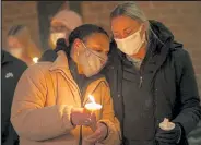  ?? Timothy Hurst / Staff Photograph­er ?? Haleigh Banks, left, and Amy Helling comfort one another during a candlelit vigil and prayer Wednesday for the victims of the mass shooting at King Soopers. The prayer service was at Cornerston­e Boulder.