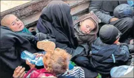  ?? AFP ?? Women and children flee the last tiny pocket of Islamic State territory in Baghuz, eastern Syria.