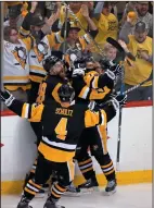  ?? AP PHOTO/GENE J. PUSKAR ?? Pittsburgh Penguins' Chris Kunitz, centre, celebrates his series-winning goal with Ian Cole, left, Sidney Crosby, right, and Justin Schultz (4) in the second overtime period of Game 7 of the Eastern Conference final in Pittsburgh.