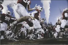  ?? JED JACOBSOHN/AP ?? STANFORD PLAYERS RUN ONTO THE FIELD for the team’s game against Notre Dame in Stanford, Calif. Saturday.