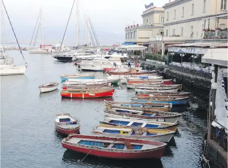  ??  ?? The waterfront in Naples isn’t always easy to reach, but it remains a busy and picturesqu­e harbour.