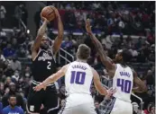  ?? MARK J. TERRILL — THE ASSOCIATED PRESS ?? Kawhi Leonard, left, scored 44 points in the Clippers' 176-175double-overtime loss to Sacramento on Friday.