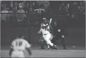  ?? HARRY HARRIS — THE ASSOCIATED PRESS FILE ?? Atlanta Braves' Hank Aaron eyes the flight of the ball after hitting his 715th career homer in a game against the Los Angeles Dodgers in Atlanta, Ga., on April 8, 1974. Aaron broke Babe Ruth's record of 714 career home runs.