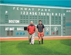  ?? Andy Kuno / San Francisco Giants ?? Hall of Famer Carl Yastrzemsk­i walks with grandson Mike in front of the Green Monster before the Giants’ rookie made his debut at Fenway Park.