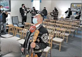  ?? STACEY WESCOTT/CHICAGO TRIBUNE PHOTOS ?? Enrique Leon, founder of Mariachi Mexico Vivo, sings during the funeral service for friend and fellow musician Florentino Chavez at Martinez Funeral Home on Dec. 6 in Chicago.