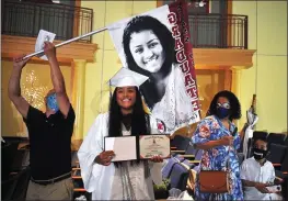  ??  ?? Aleah Rebeiro, a member of Lincoln High School’s Class of 2020, is surprised with a graduation banner with her picture on it.