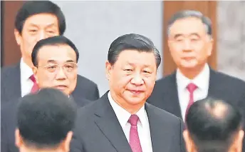  ?? — AFP file photo ?? Xi (centre) arriving with Premier Li Keqiang (left) for a reception at the Great Hall of the People in Beijing on the eve of China’s National Day.