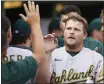  ?? CARLOS OSORIO — THE ASSOCIATED PRESS ?? The A's Sheldon Neuse is greeted during the second game of a doublehead­er against the Tigers.