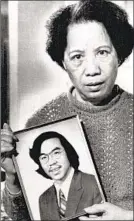  ?? Richard Sheinwald Associated Press ?? LILY CHIN holds a photo of her son, Vincent, who was killed in June 1982.