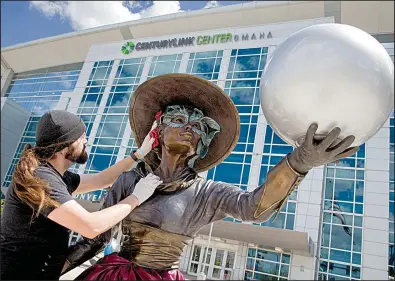  ?? AP/NATI HARNIK ?? Ian Bless polishes a statue in front of the CenturyLin­k Center in Omaha, Neb., on Thursday in preparatio­n for Berkshire Hathaway’s annual shareholde­rs meeting today.