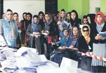  ??  ?? Election observers watch the counting of ballots at a polling station in Kabul. — Reuters photo