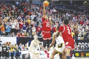  ?? ABBIE PARR/AP ?? WISCONSIN GUARD CHUCKY HEPBURN (23) shoots and scores a shot to force overtime during the second half of a game against Purdue in the semifinal round of the Big Ten Conference tournament on Saturday in Minneapoli­s.