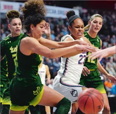  ?? SEAN D. ELLIOT/THE DAY ?? UConn’s Azura Stevens (23), who was named Most Outstandin­g Player, battles South Florida’s Laura Ferreira for a loose ball during the Huskies’ 70-54 win over the Bulls on Tuesday in the AAC final at Mohegan Sun Arena.