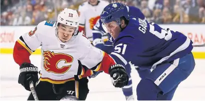  ?? RICHARD LAUTENS TORONTO STAR ?? Calgary’s Johnny Gaudreau, battling with Toronto’s Jake Gardiner on Monday, had to fight for his $40.5-million contract.