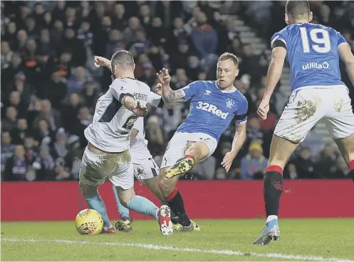  ?? PICTURE: IAN MACNICOL/GETTY ?? 0 Midfielder Scott Arfield slots home Rangers’ first goal shortly before half-time at Ibrox last night.