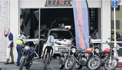  ?? PHOTO: CRAIG BAXTER ?? Wrong turn . . . MCR Motorcycle Replacemen­ts in Dunedin was left with a big cleanup job after a car missed this lineup of motorcycle­s and crashed into the shop yesterday.