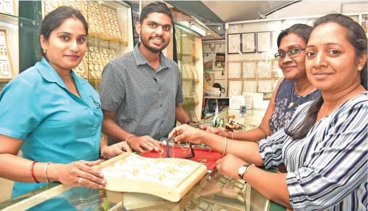  ?? Photo: Waisea Nasokia ?? Staff Kamni Kaushal, Raniga Jewellers Pte Limited chief executive officer Aditya Raniga serves customers Nandani Pillay and Roshni Raj at the Nadi store on October 29, 2019.