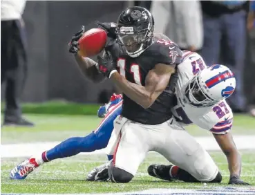  ?? THE ASSOCIATED PRESS ?? Falcons wide receiver Julio Jones makes a 5-yard reception in front of Buffalo Bills cornerback Tre’Davious White during the first half of their game Sunday in Atlanta.