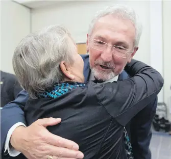  ??  ?? Nanaimo mayor-elect Leonard Krog hugs a supporter after his election win Saturday. Krog, who took unpaid leave as an MLA to run for mayor, has yet to decide when his last day in the legislatur­e will be.