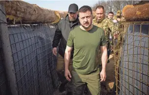  ?? UKRAINIAN PRESIDENTI­AL PRESS SERVICE VIA REUTERS ?? Ukraine’s President Volodymyr Zelenskyy inspects new fortificat­ions for Ukrainian servicemen on Tuesday. Ukraine claims its air defense system destroyed 20 attack drones Monday.
