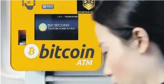  ?? AP ?? A woman uses a Bitcoin ATM in Hong Kong after South Korea said it was weighing a trading ban.