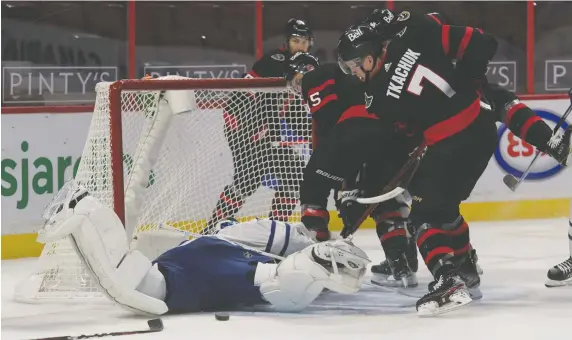  ?? MARC DESROSIERS/USA TODAY SPORTS FILES ?? Leafs goalie Frederik Andersen lies prone on the ice as Sens winger Brady Tkachuk barges in after the loose puck during action last weekend.