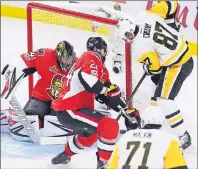  ?? CP PHOTO ?? Pittsburgh Penguins’ Sidney Crosby tucks the puck in the net past Ottawa Senators goalie Craig Anderson as Senators’ Viktor Stalberg defends during the second period of game four of the Stanley Cup eastern conference finals in Ottawa on Friday.