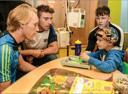  ??  ?? Diarmuid O’Keeffe (left), Laois footballer Colm Begley, and former Carlow hurler Hugh Paddy O’Byrne spending some time with six-year-old Zach King from Ballincoll­ig, Co. Cork, at last week’s campaign launch.