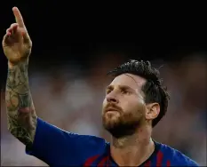  ??  ?? Barcelona forward Lionel Messi celebrates after scoring the opening goal for his team during the group B Champions League soccer match between FC Barcelona and PSV Eindhoven at the Camp Nou stadium in Barcelona, Spain, on Tuesday.AP Photo/mAnu FeRnAnDez
