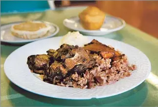  ??  ?? OX TAIL with rice and peas, plantains and coconut pie: Belizean comfort food at Joan and Sisters.